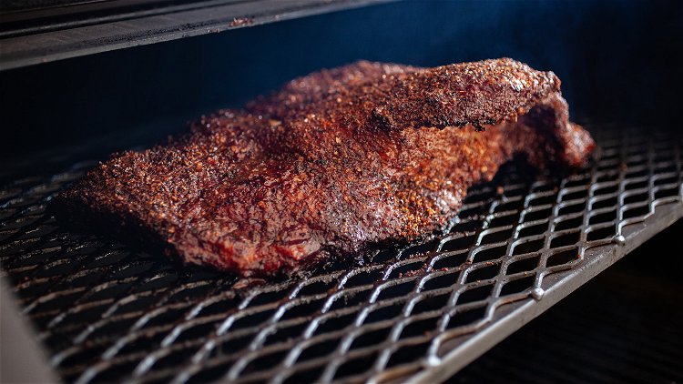 Image of Smoke the brisket on the second shelf of the grill,...