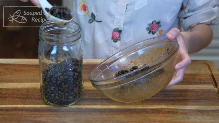 Image of Put the black beans into a wide-mouth mason jar.