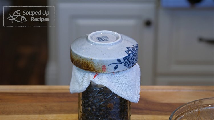 Image of Cover the mason jar with a clean cheesecloth, tie the...