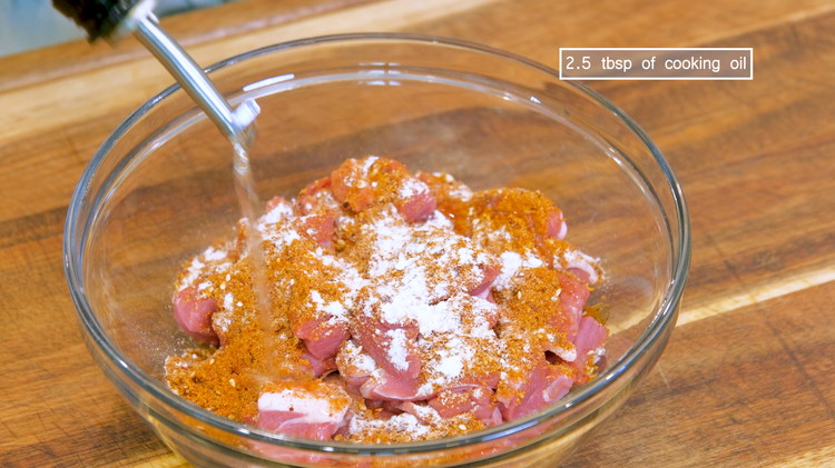 Image of Cut the meat into bite-size pieces, then season with 3 tbsp of the BBQ spice rub, 1/3 tsp of baking soda, and a big drizzle of cooking oil.