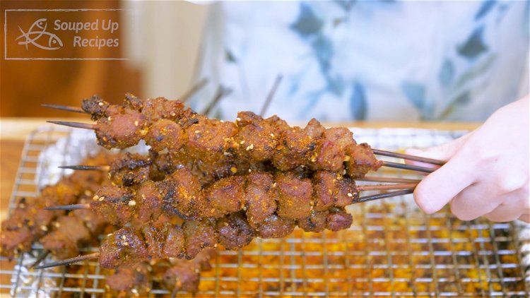 Image of Take the lamb skewers out and sprinkle more of the...