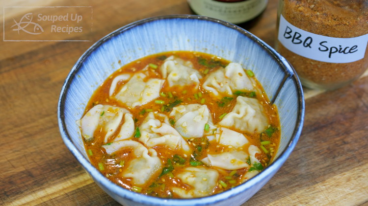 Image of Add the wontons into the bowl, pour in 1.5 cups of the boiling broth, and mix well.