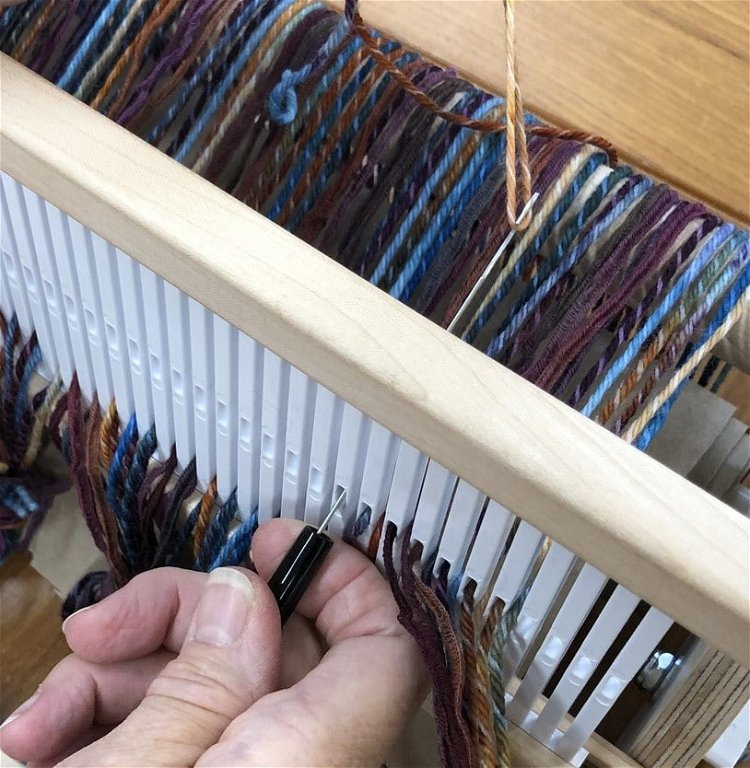 Image of Thread the heddle. Take one end out of the slot...