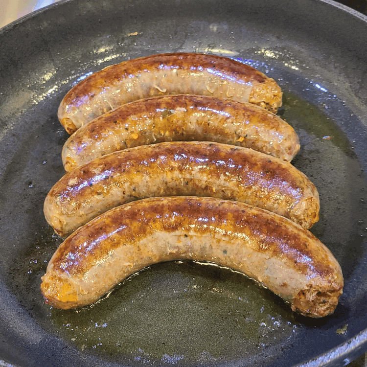 Image of Add the sausage to the skillet and cook for 5-8 minutes. Remove from the pan and set aside. Allow the sausage to cool slightly, and then slice it into rounds.