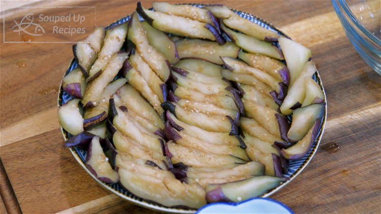 Image of Intentionally arrange the eggplant on a plate with the skin...