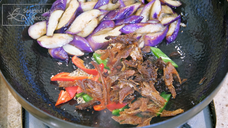 Image of Push the eggplant to the side of the wok so you have room to add the minced ginger, garlic, green and red chili, the fermented black beans from the can, and the fish meat. Stir over low heat until fragrant,...