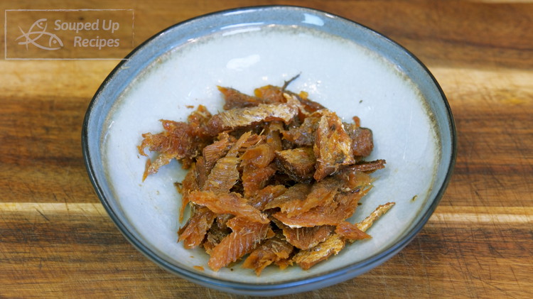 Image of Open a can of fried dace and break the fish into small pieces. Reserve the oil and fermented black beans on the side.