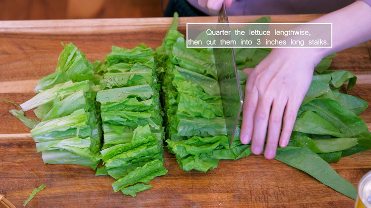 Image of Quarter the you mai cai lettuce lengthwise, then cut it into 3-inch long stalks.