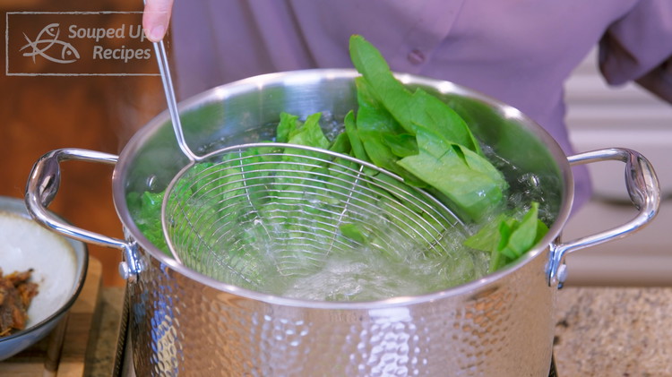 Image of Bring a pot of water to a boil and add a big drizzle of oil. Toss in the you mai cai lettuce and let it blanch for 15 seconds. The oil will coat the surface of the vegetables and help...