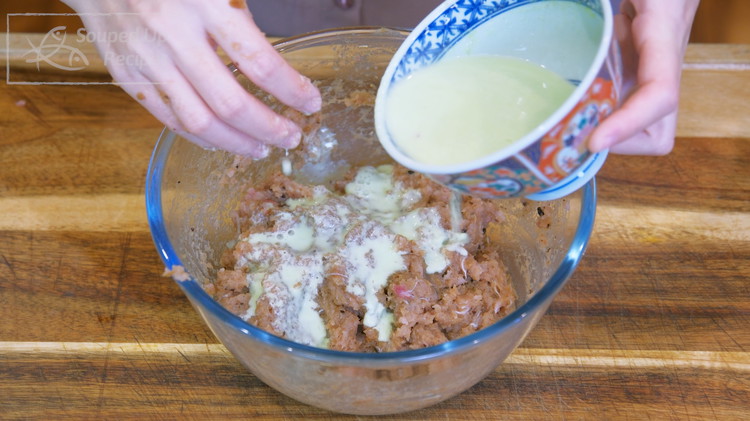 Image of Pour the aromatic starch water in batches and whisk the meat until the liquid is absorbed. Add a little bit more and continue to mix. Repeat that until all the starch water is finished.