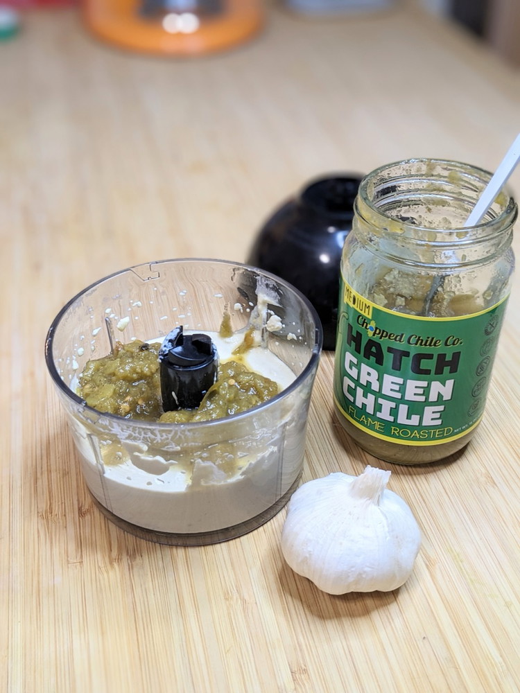 Image of Combine egg yolks, garlic, and lime juice in a small food processor or in a deep mixing cup with an immersion blender. Mix until well emulsified. The mixture will be thick and opaque.