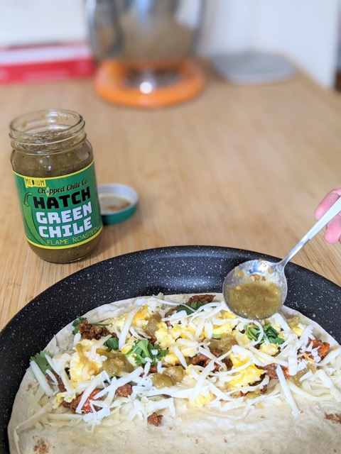 Image of Lay out four large flour tortillas and divide half the Monterey Jack evenly, covering one half of each tortilla. Layer each quesadilla with chorizo, scrambled egg, cilantro, and Chopped Chile Co. Green Hatch Chiles. Top with remaining half of Monterey...