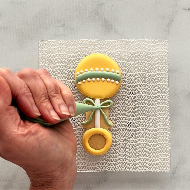 Image of How to Decorate a Baby Rattle Cookie with Royal Icing