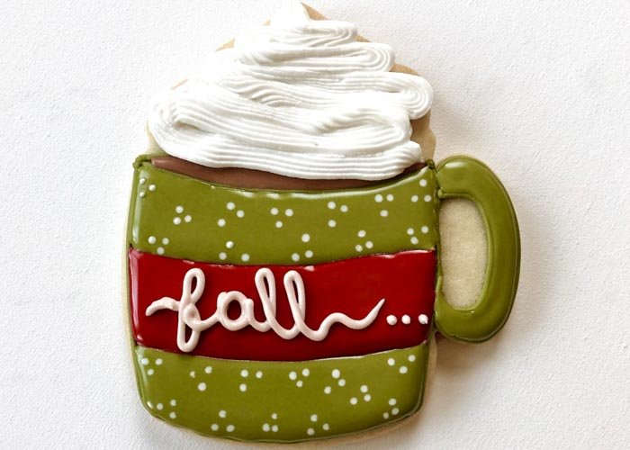 Image of Use your white piping consistency icing to add details. You can pipe more dots or some lettering in the red strip. Add some confectioner's sugar to your white piping consistency icing until it is stiff consistency-meaning it holds its shape. Using a piping bag with a star tip, pipe swirls of whipped cream on top of your mug. 