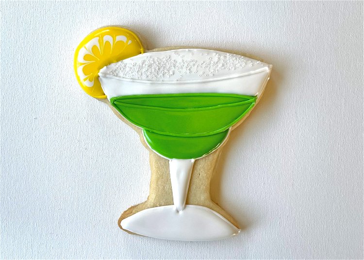 Image of If you'd like to add more texture, outline the top of the glass with white piping consistency icing, and the three green sections with green piping consistency icing. 