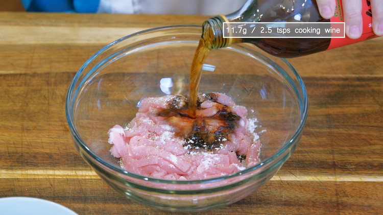 Image of Place the meat into a bowl and add 1/2 tsp salt, 1/4 tsp ground white pepper or to taste, 1 tsp dark soy sauce, 1/4 tsp of baking soda, and 2.5 tsps cooking wine. Mix thoroughly and let sit for...