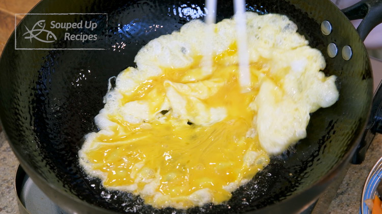 Image of Heat a wok over high heat until it is lightly smoking. Add a big drizzle of oil and pour in the egg. Wait 10 seconds for the egg to set. Please give it a little help to let the uncooked...
