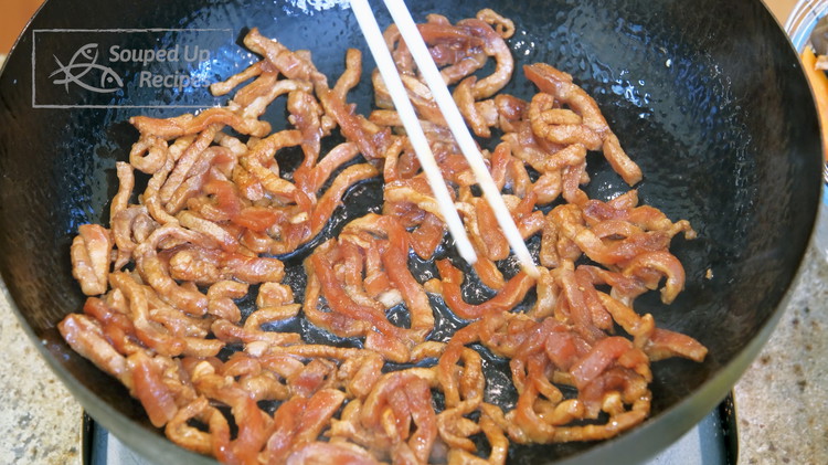 Image of Turn the heat back on high and drizzle more oil to the same wok. Add the marinated pork. Carefully loosen the meat strips so they don’t tangle together and let it sear. Continue to stir for 2 minutes or until...