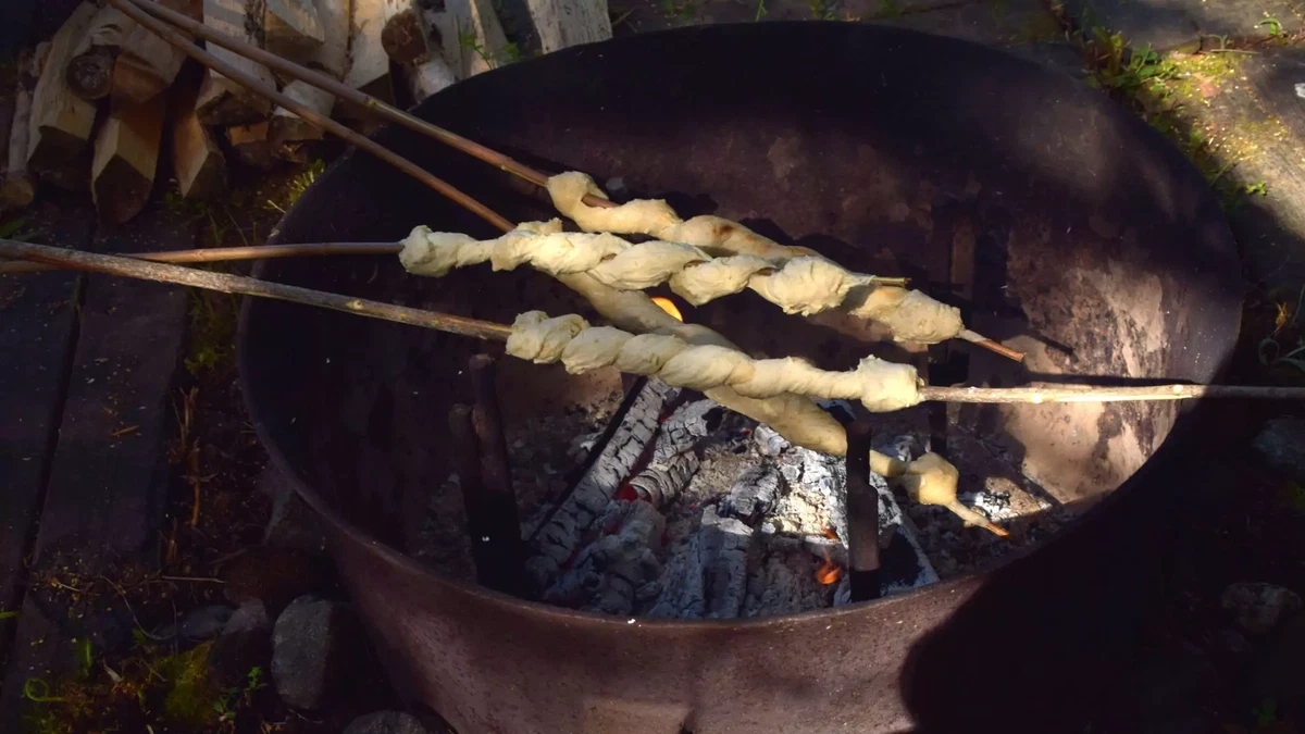Wild herb campfire bread on a stick