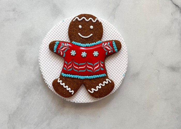 Image of This sweet sweater design adds some nice visual interest to a traditional gingerbread man shape.