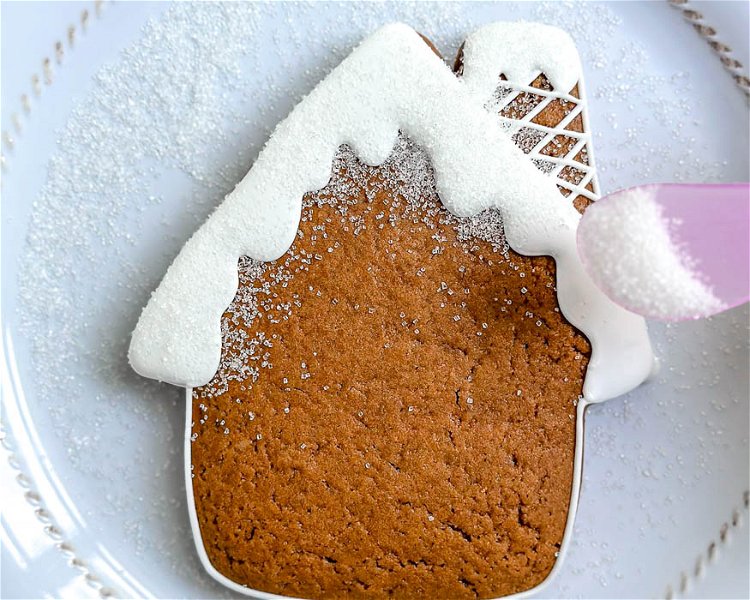 Image of Carefully place the cookie onto a clean plate. Sprinkle the white sanding sugar onto the 