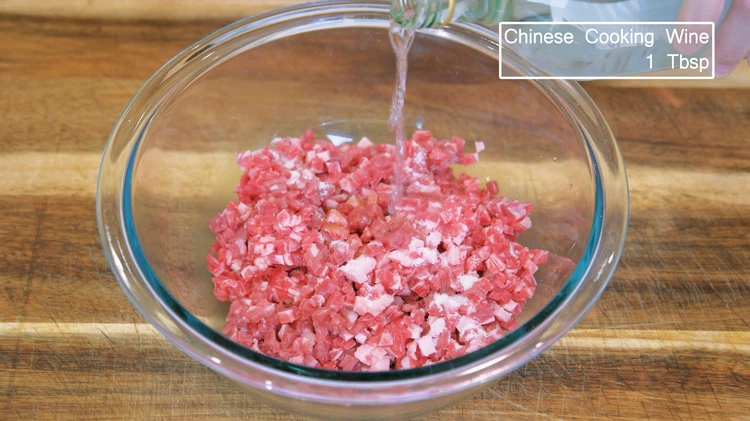 Image of Season the ground beef with 1 tsp of salt, 1.5 tsp of soy sauce, and 1 tbsp of Chinese cooking wine. Mix until well combined.  Please do not stir in one direction because we want the beef bites to be...
