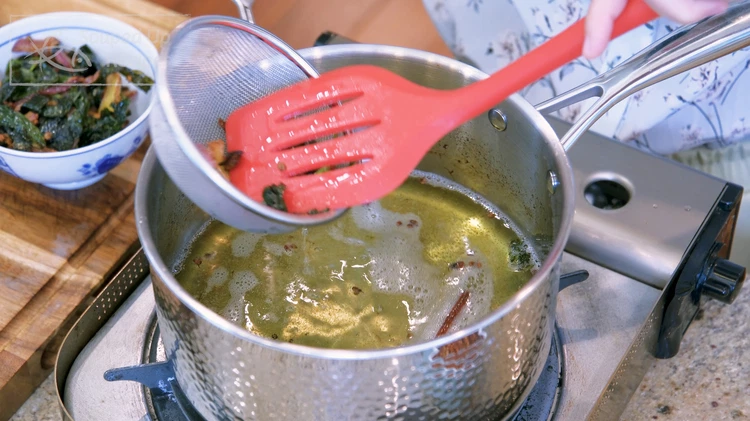 Image of Use a strainer to sieve out all the aromatics and leave the oil behind. We don't need the aromatics for this recipe any more, but you can toss them into homemade stock, and they will add so much fragrance to...