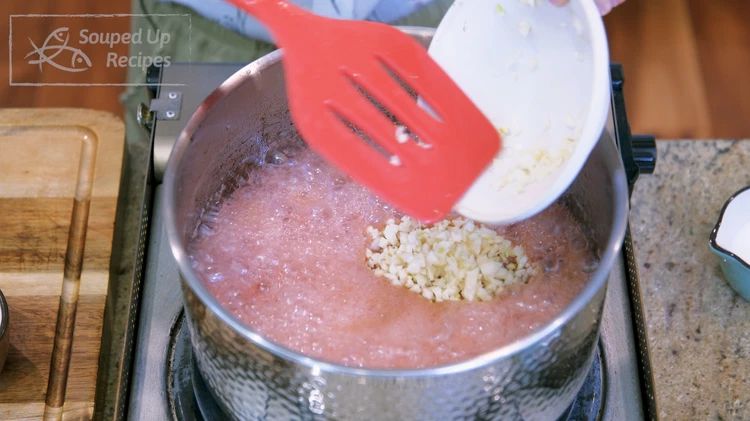 Image of Add the seasoned ground beef and minced garlic to the oil and stir over medium heat for 5 minutes or until the garlic is slightly golden. It is very normal to see foamy bubbles during this process; don't freak out.