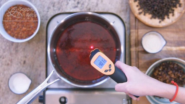 Image of Turn the heat to high and bring the oil's temperature to 400F. This is important because we need the heat to activate the fragrance of the sesame, chili flake, and fermented black beans.