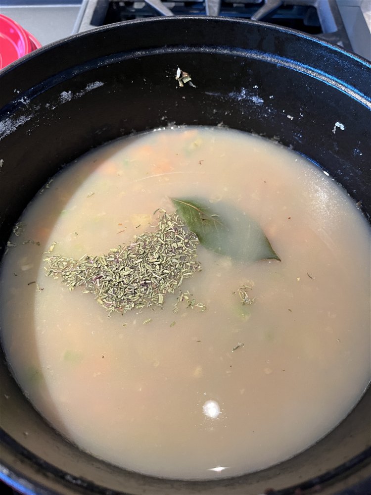 Image of Add 2 cups chicken broth, reserved clam juice, bay leaf,...