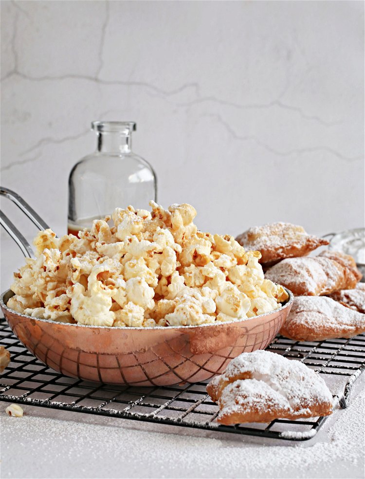 Image of Add the popped popcorn to a large bowl and pour...