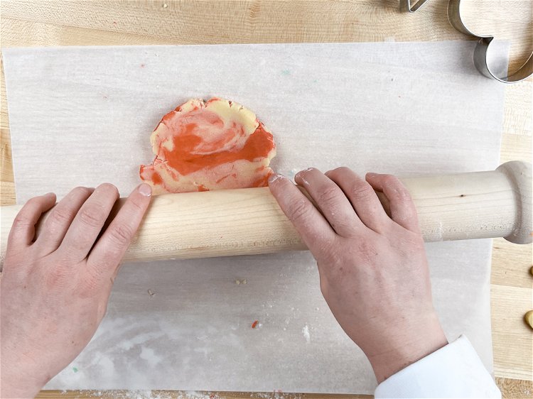 Image of Roll out the ball of dough to 1/4 inch. Our Perfect Cookie Rolling Pin takes the guesswork out of this step--its fixed depth handle results in perfectly 1/4 inch cookies every time for even baking.
