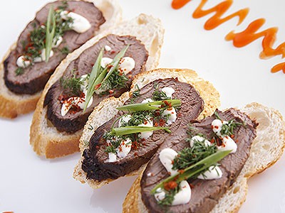 Image of Beef Tenderloin Crostini, Caramelized Onions Blue Cheese