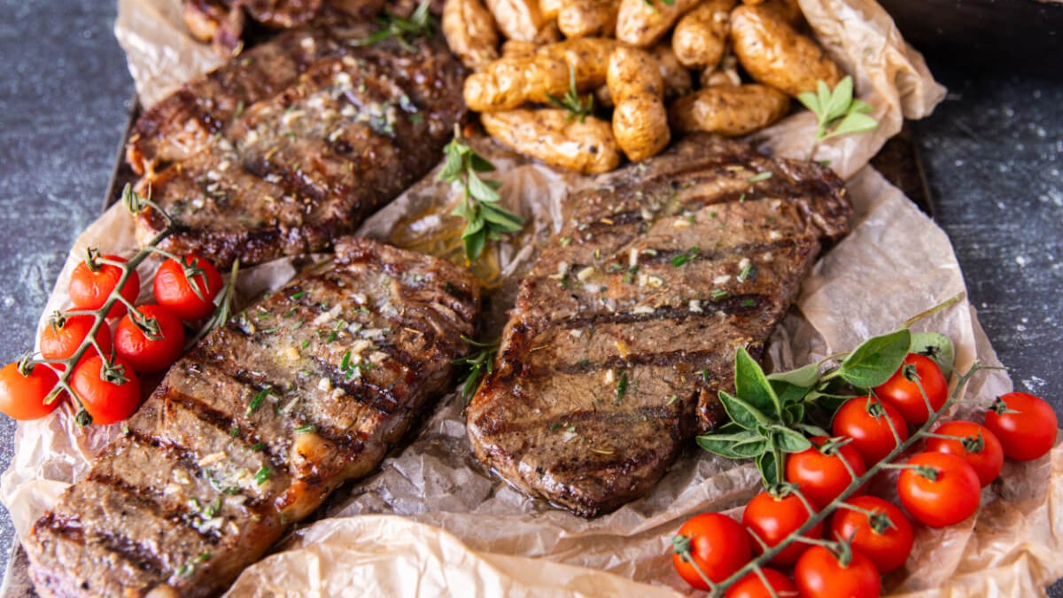Image of Ribeye Steaks On The Grill With Rosemary Butter, Panzanella Salad & Potatoes