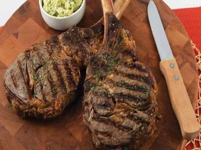 Image of Grilled Tomahawk Ribeye Steaks with Classic Steak Butter