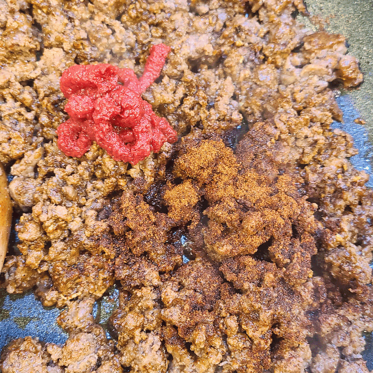 Image of Stir in the taco seasoning, tomato paste, and water. Simmer for 5-7 minutes until the mixture thickens.