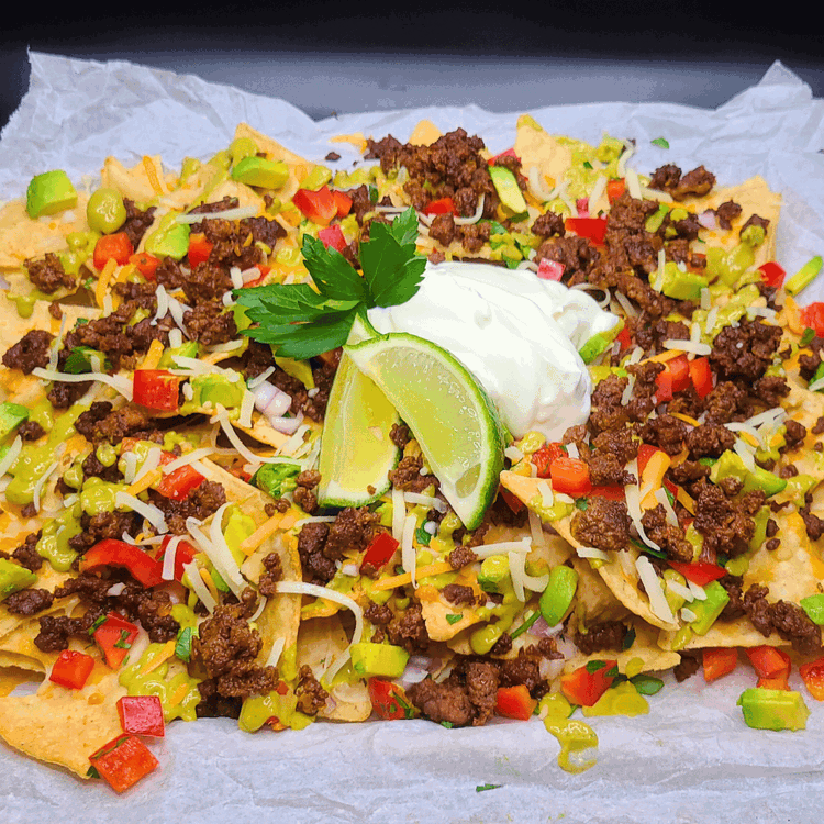 Image of Squeeze lime over the nachos before indulging in this delightful combination of flavors. Share with friends and family as a delicious appetizer or enjoy it as a satisfying meal on its own. These nachos go great with a nice cold...