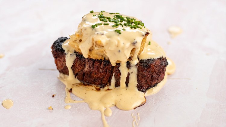 Image of Serve the filets topped with crab cakes and hollandaise sauce...