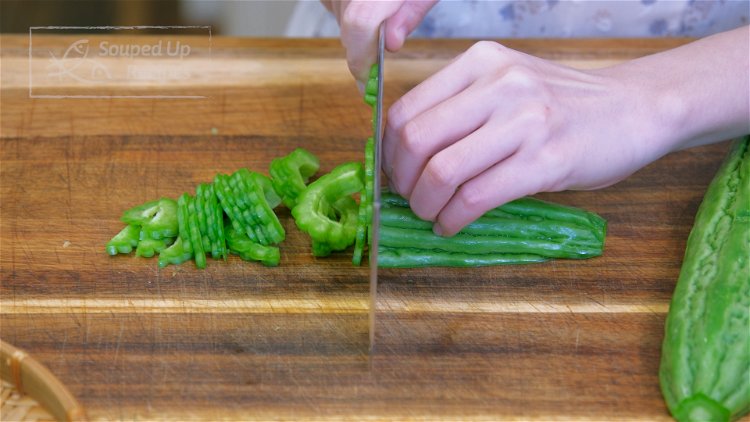 Image of Discard both ends of the bitter melon and cut it...