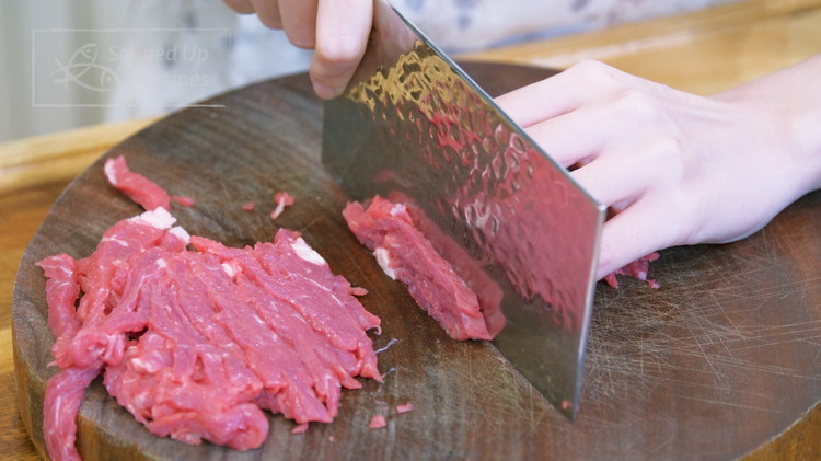Image of Slice the beef into thin slabs, stack the slabs, and thinly julienne them. You can use beef chuck, flank steak, and sirloin.