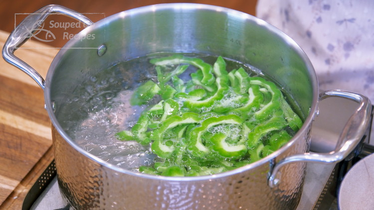 Image of Bring a pot of water to a boil. Add a big drizzle of oil and toss in the bitter melon slices. The oil will coat the vegetable surface and retain the vivid green color. Let the bitter melon blanch for...
