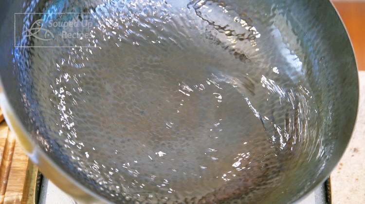Image of Turn the heat to high and heat a wok until smoking hot. Drizzle a generous amount of oil and swirl it around to create a non-stick layer.
