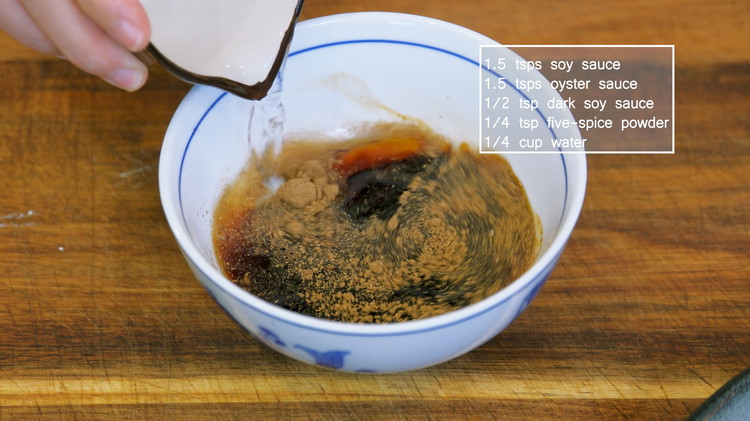 Image of Before cooking, put together all the seasonings: 1.5 tsps soy sauce, 1.5 tsps oyster sauce, 1/2 tsp dark soy sauce, 1/4 tsp five-spice powder, and 1/4 cup water. Mix well and set it aside.
