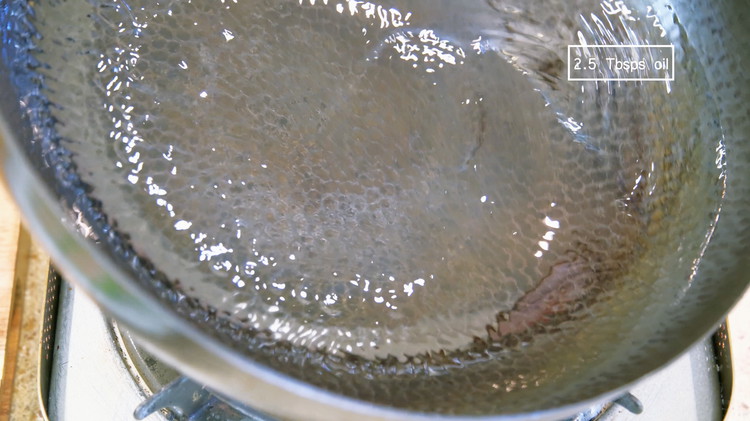 Image of Preheat your wok over medium heat for about 30 seconds. Add a big drizzle of oil and swirl it around.