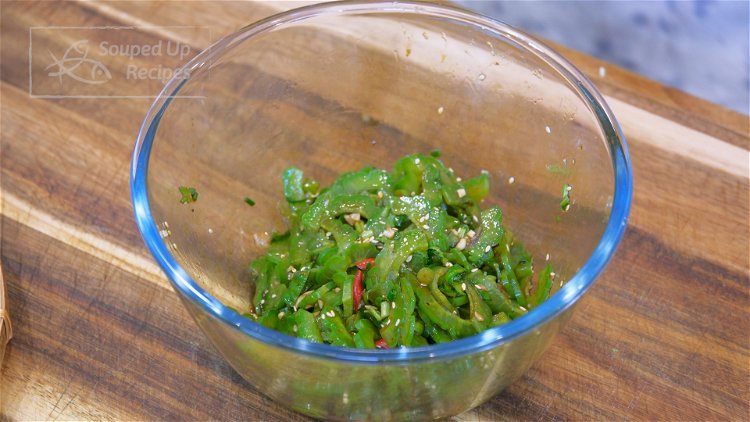 Image of Add the blanched bitter melon and mix thoroughly.