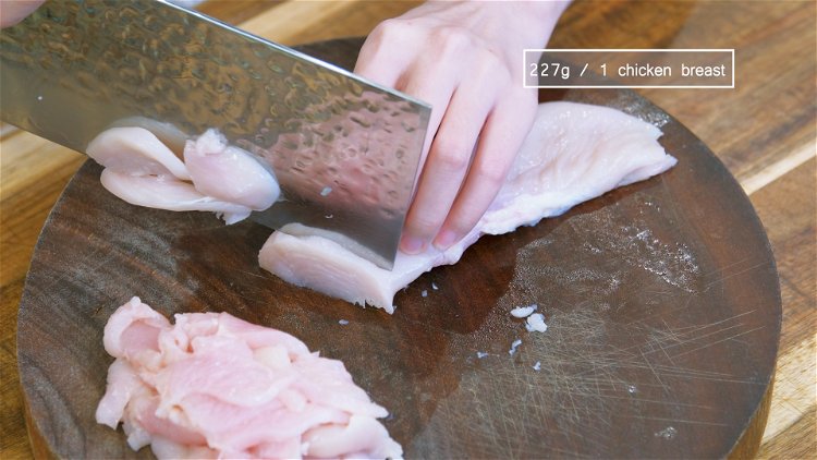 Image of Slice the chicken breast into two big strips. Then cut...