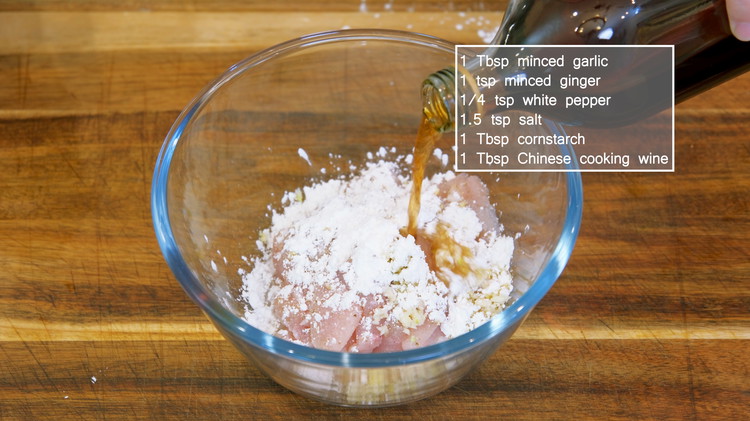 Image of Marinade the chicken with minced garlic, ginger, white pepper, salt, cornstarch, and Chinese cooking wine. Mix well and set it aside for 10 minutes.