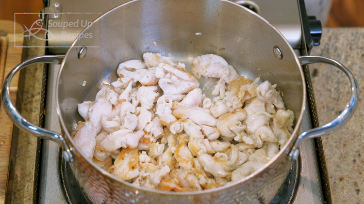 Image of Heat a stock pot over medium heat for 40 seconds. Add oil and swirl it around to cover the bottom. Add the marinaded chicken and stir over high heat for 2 minutes or until the meat is slightly charred.