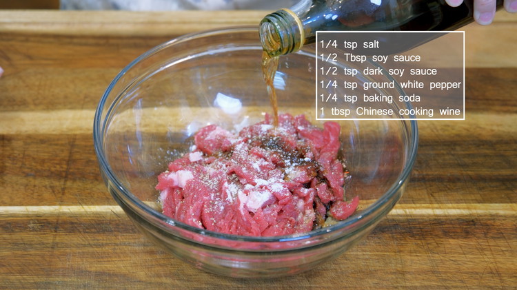 Image of Marinade the meat with salt, soy sauce, dark soy sauce, white pepper, baking soda, and Chinese cooking wine and mix well. Add a drizzle of cooking oil and mix to coat the beef. This helps to separate the meat strips...