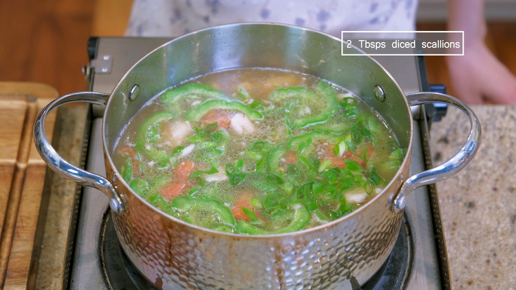 Image of Cut a tomato into bite-size pieces and add to the soups to bring a pot of color. Turn off the heat and sprinkle some diced scallions as garnish.
